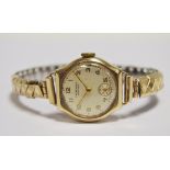 A lady's 9ct gold wristwatch, silvered dial with subsiduary seconds dial, J W Benson, London, gold