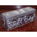 An early 20th century silver rounded rectangular snuff box, hinged cover embossed with figures of
