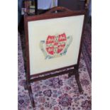 An early 20th century oak rectangular fire screen, turned finials, the tapestry banner with