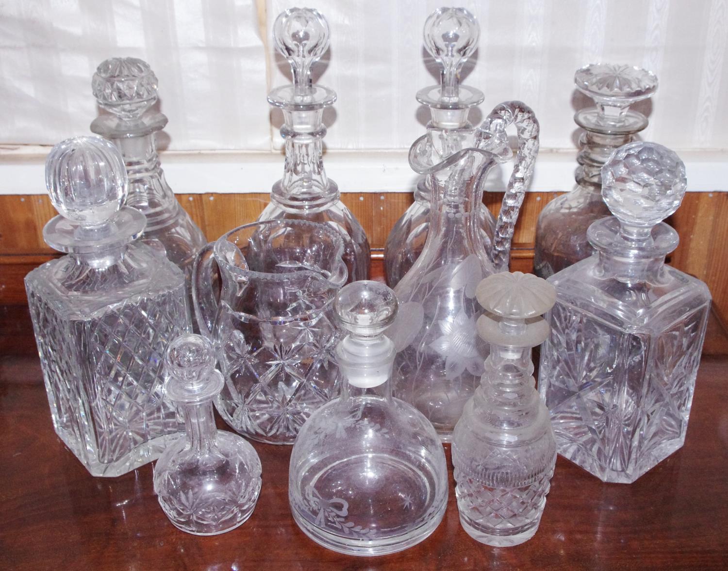 A pair of clear glass decanters, globular stopper; others, various designs; etc **Please note all