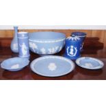 A Wedgwood Blue Jasperware bowl, typically applied in white with classical figures, 20cm diam,