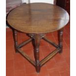 A late 17th/early 18th century circular occasional table, the top of plank construction above a stop