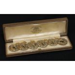 A set of six Art Nouveau gilt buttons, cased