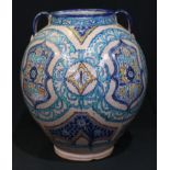 A large Islamic maiolica two handled vessel, signed to base, 35cm high