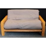 An oak framed sofa bed, Vienna by Futon Company, the frame (in sofa form) 71cm high, 156cm wide,