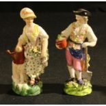 A pair of Derby figures, Gardener and Companion, he holds a spade and a flowerpot, she a basket