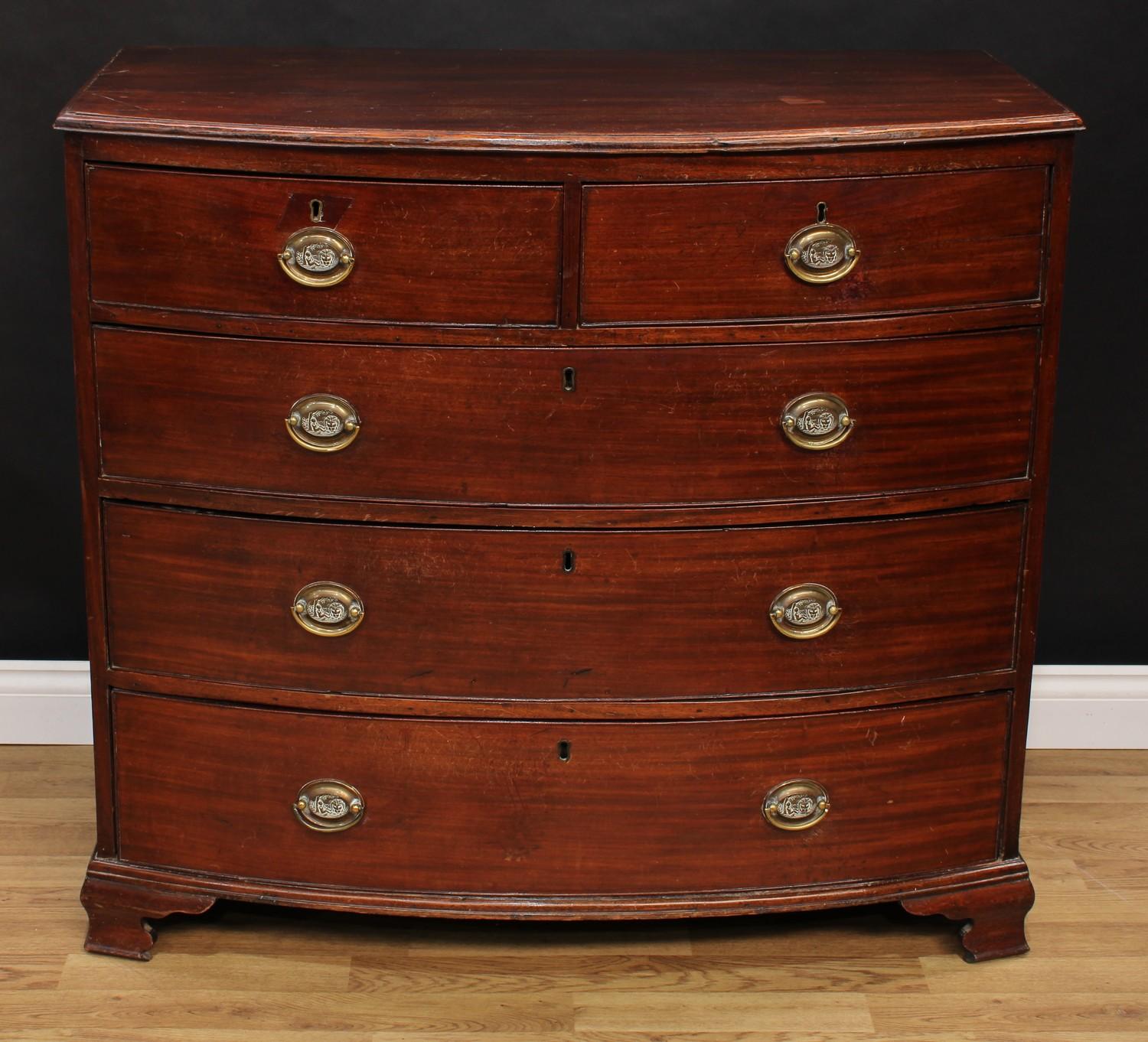 A Regency mahogany bow-front chest, slightly oversailing top with moulded edge above two short and