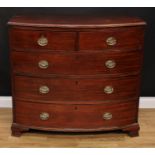 A Regency mahogany bow-front chest, slightly oversailing top with moulded edge above two short and