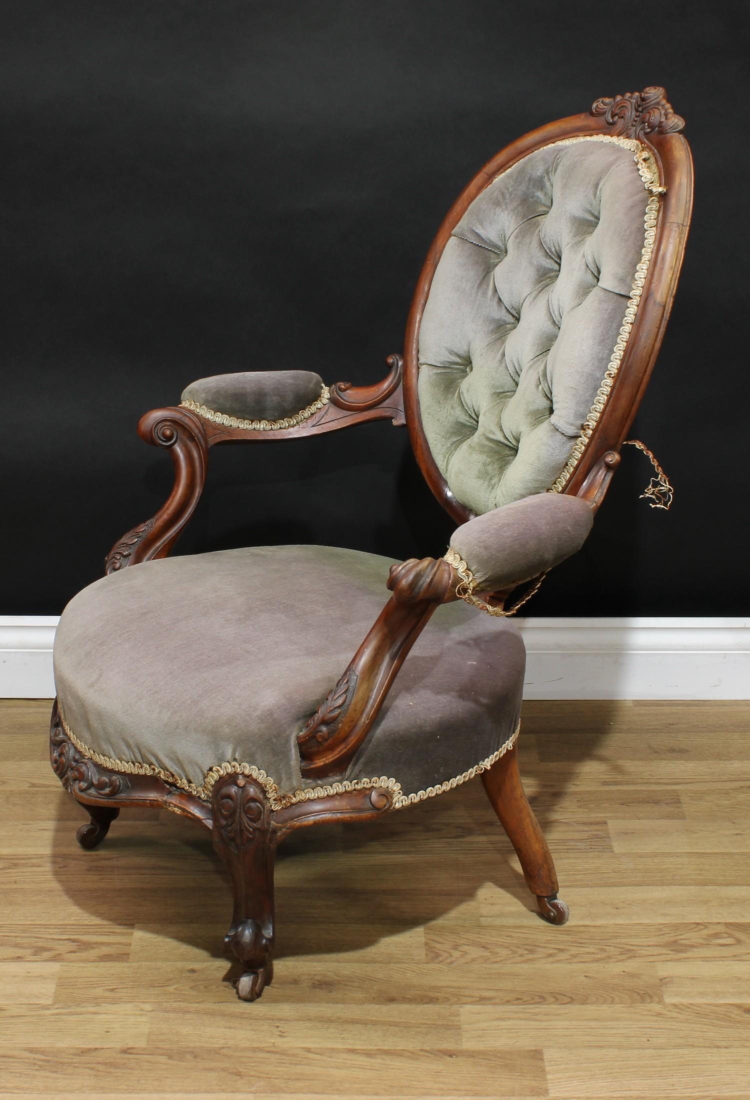 A Victorian walnut boudoir chair, oval back with scrolling foliate cresting, deep-button back, bowed - Image 3 of 3