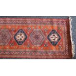 A Middle Eastern silk rug, 227cm x 70cm