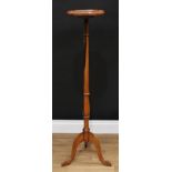 A George III style rosewood candle stand, dished shaped square top with re-entrant angles, turned