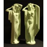 A pair of Art Deco style green glazed statues, modelled as a pair of scantily clad beauties, 51cm