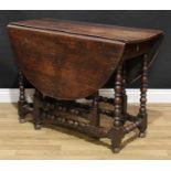 An 18th century oak gateleg dining or breakfast table, oval top with fall leaves, drawer to