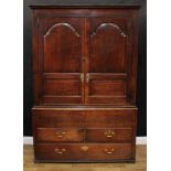 A George III oak housekeeper's or press cupboard, shallow outswept cornice above a pair of raised