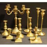 Metalware - a George III brass candlestick, c.1820; a pair of Victorian brass candlesticks, c.