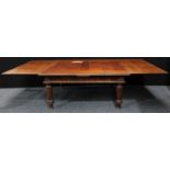 A substantial walnut veneered draw-leaf dining table, rectangular top with two extending leaves,