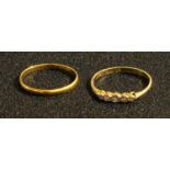 A 22ct gold wedding band, 1.62g; an 18ct gold five stone illusion set diamond ring, 2g (2)
