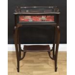 An Edwardian ebonised bijouterie display table, hinged cover with glazed top and sides, above a