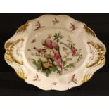 A Sampson shaped oval serving plate, painted with fanciful birds, moulded with shells and scrolls,