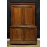 An early 20th century oak housekeeper's cupboard, moulded cornice above a pair of panel doors