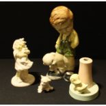 A Bretby model of a boy and puppy, 25cm; another smaller, girl and doll; a Bretby duckling lamp