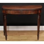 A George III mahogany D-shaped tea table, hinged top with reeded edge above a deep frieze, tapered