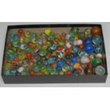 A collection of 20th century children?s glass marbles, mostly small examples, some medium sized 22mm