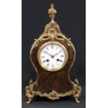 A Louis XV Revival metal mounted boulle and ebonised cartouche shaped mantel clock, 9cm circular