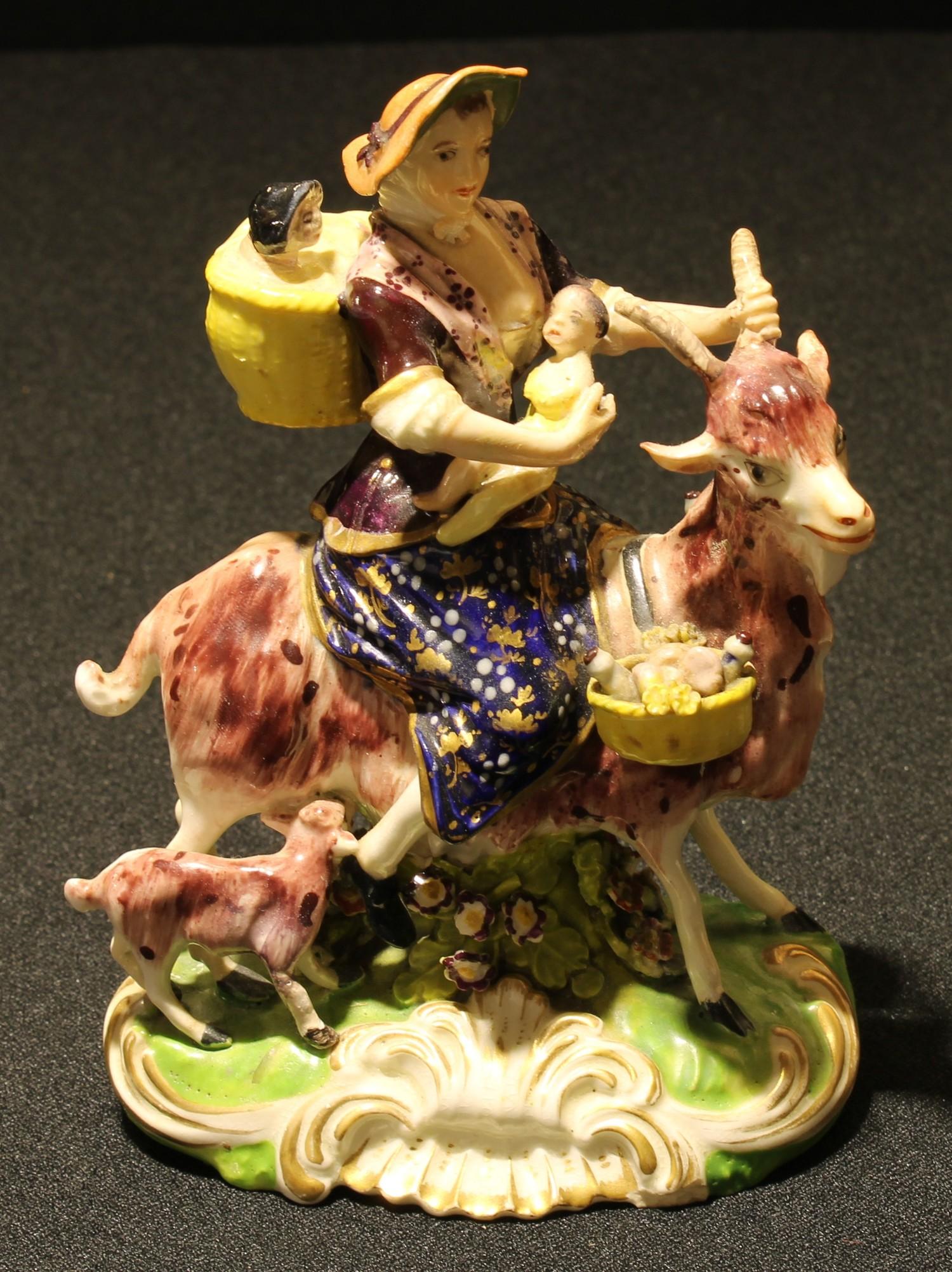 A Derby figural group, The Welch Tailor's Wife, typically modelled, painted in polychrome and picked