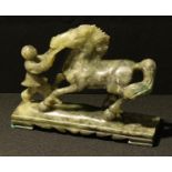 A Chinese jade coloured hardstone carving of a horse and figure, 19cm long
