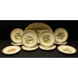 A Limoges fish service, comprising oval platter and ten plates, printed with assorted varieties of