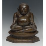 South-East Asian School, a brown patinated bronze, of a Buddhist disciple, possibly Phra