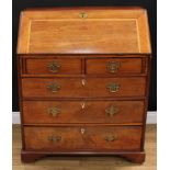 A George III mahogany bureau, fall front enclosing a baize lined writing surface, a small door,
