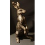 A bronzed resin model of a hare, he stands upright and alert, 45cm high