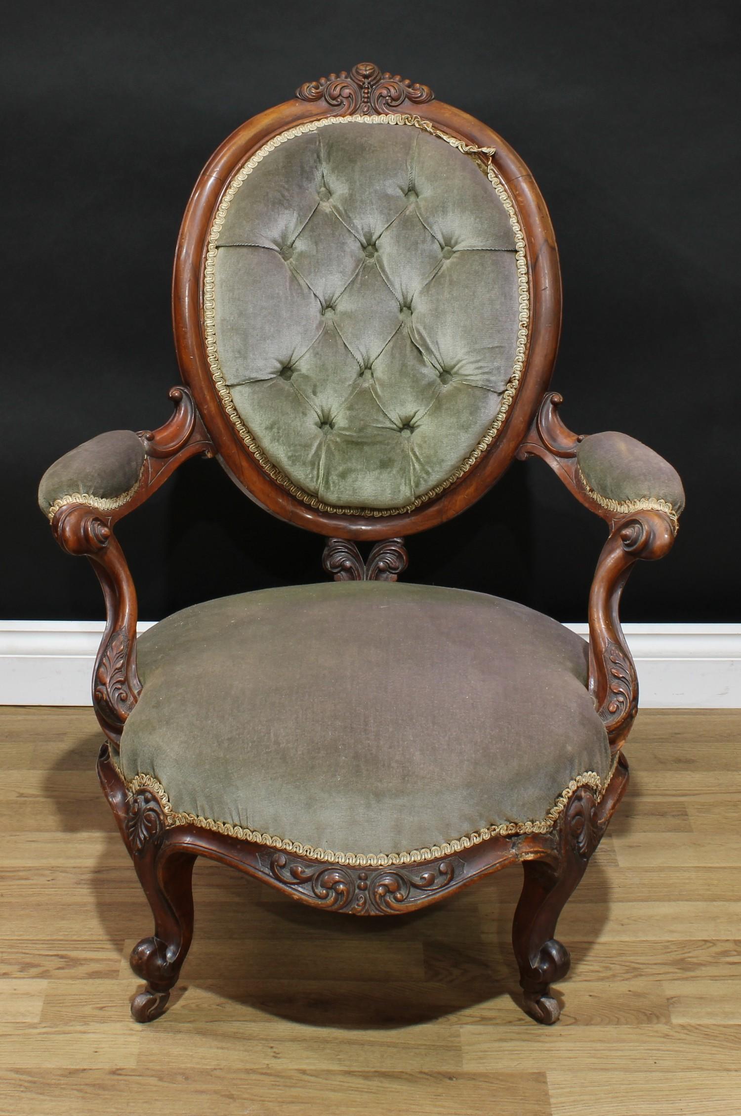 A Victorian walnut boudoir chair, oval back with scrolling foliate cresting, deep-button back, bowed - Image 2 of 3