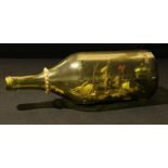 A ship in a bottle, model of an 1885 Tea Trader, green Martel Cognac bottle