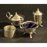 Silver - a circular napkin ring, Birmingham 1942; a silver three piece condiment set, pad feet,