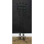 A wrought iron floor standing ecclesiastic style four branch candelabrum, 127cm high, the base
