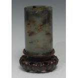 A Chinese russet jade cylinder brush pot, quite plain, the carved in relief with concentric bands,