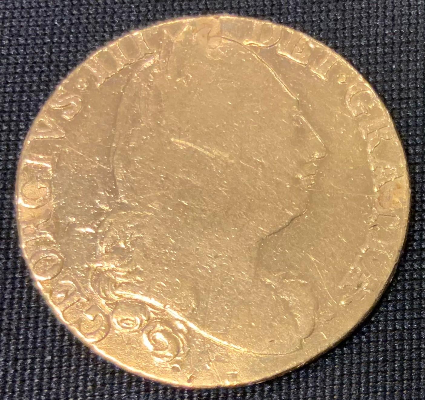 An 18th Century George III 1774 gold spade guinea coin having a laureate bust of King George and