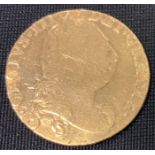 An 18th Century George III 1774 gold spade guinea coin having a laureate bust of King George and