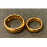 A 22ct gold half barrel wedding band, size T, Birmingham, 1916; another size K, Birmingham, 1921