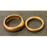 A 22ct gold half barrel wedding band, size O, Birmingham, 1910; another size L, Birmingham total