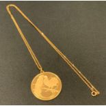A French 18ct gold pendant, cast in relief with two fancy doves to the obverse, the reverse engraved