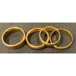 A 22ct gold half barrel wedding band, size M 1/2, London, 1910; another size K, Birmingham, 1960;