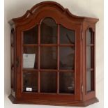 A mahogany wall hanging serpentine fronted cabinet, 69cm high, 68cm wide This lot must be