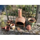 A terracotta chiminea and planters. This lot must be collected from S44 5SU on Friday 23/4/21