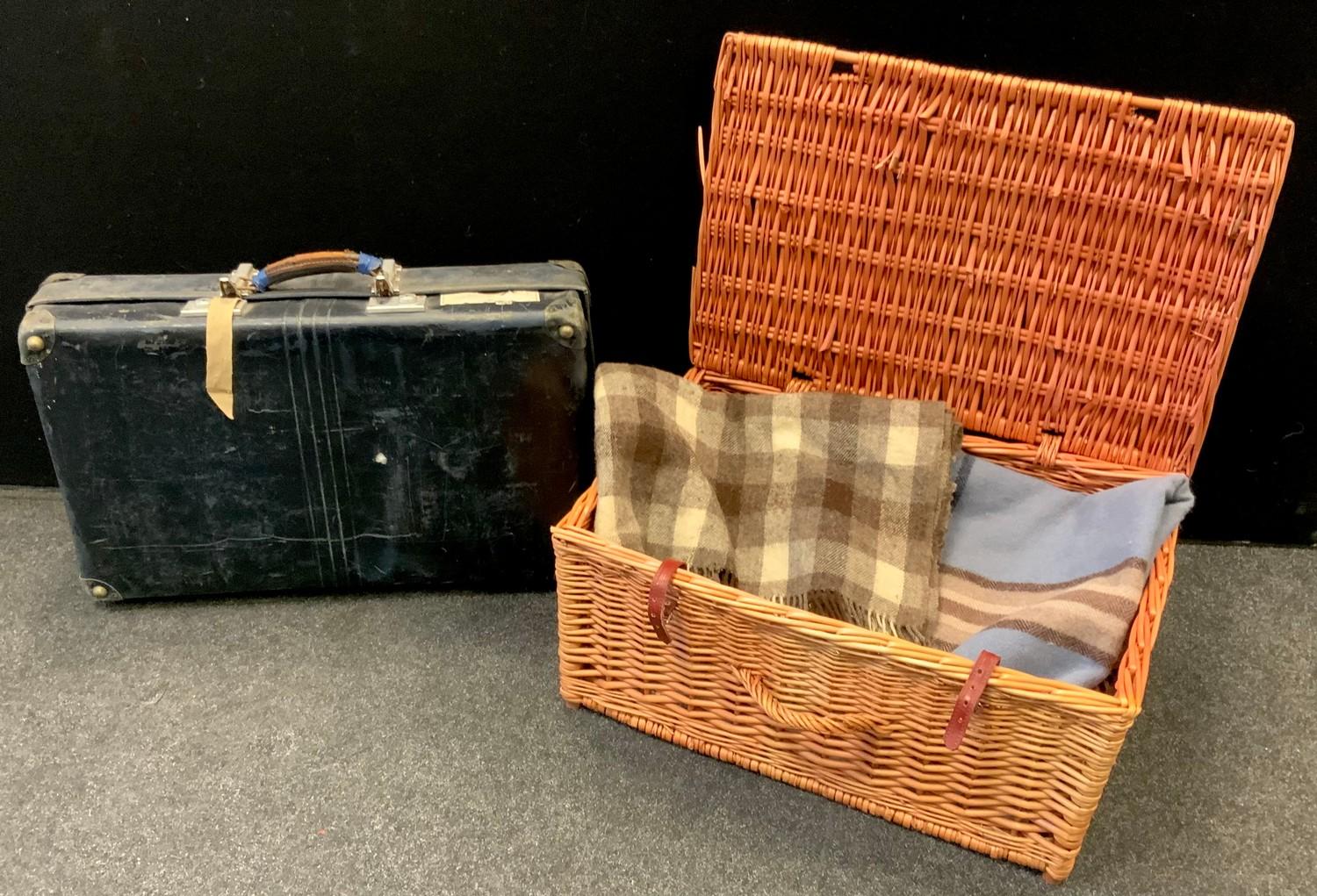 A larger wicker hamper containing blankets; a vintage suitcase etc.
