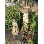 A reconstituted stone bird bath, the three muses, 92 cm high; a reconstituted stone figure,