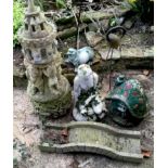 A reconstituted stone garden ornament, gnomes holding aloft a vented turret, bridge, toadstool house